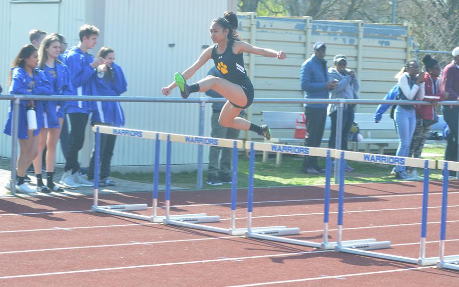 Kaesha Gavina, a student from Stuttgart, jumps over a hurdle during a track meet at Wiesbaden High School, on Saturday, March 30, 2019.
