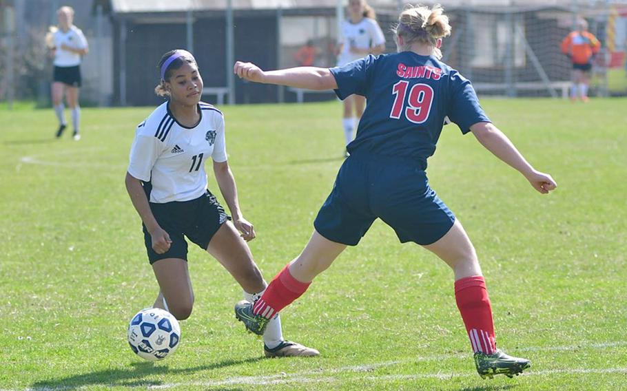Victoria Antoine, a forward with the Stuttgart Panthers, gets around Aviano's Audrey Belben-Cruz during Saturday's game that was played at the Aviano stadium. Antoine had two assists in the game, which was easily won by the Panthers 7-0.
