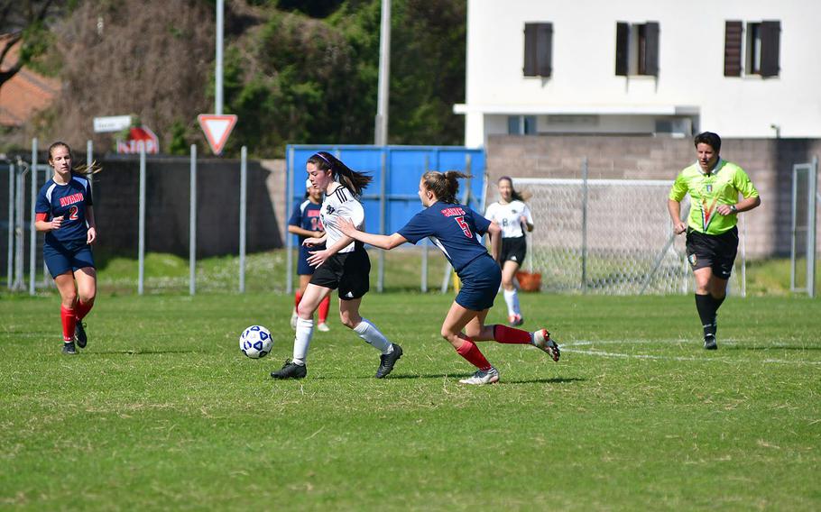 Liv Sullens, a forward for the Stuttgart Panthers, drives past Aviano defenders during Saturday's game that was played at the Aviano stadium. Sullens scored three times in the game, which the Panthers won easily 7-0. 