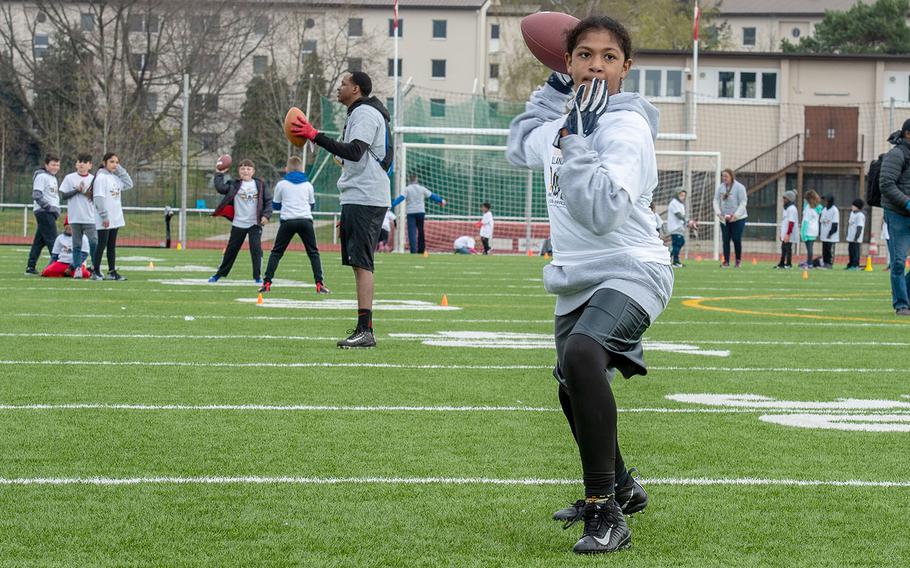 Nathaniel Romero, 14, throws a pass during a quarterback drill at a pro camp at Kaiserslautern High School football field Saturday, April 13, 2019. More than 200 kids from around Germany attended the two-day football camp.