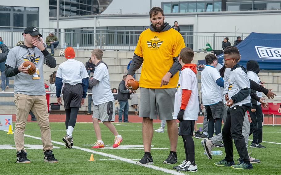 Pittsburg Steelers Offensive Lineman Alejandro Villanueva talks to his receiver before a drill during a pro camp at Kaiserslautern High School football field Saturday, April 13, 2019. More than 200 kids from around Germany attended the two-day football camp.