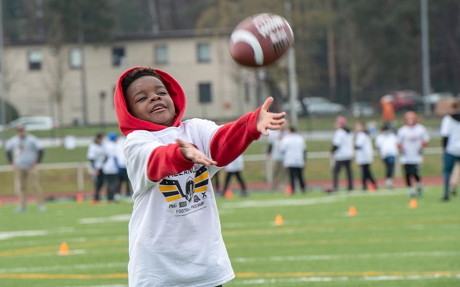 Pro camp participant Xzavier Jennings, 6, tries to catch a pass during a drill at Kaiserslautern High School football field April 13, 2019. More than 200 kids from around Germany attended the two-day football camp.
