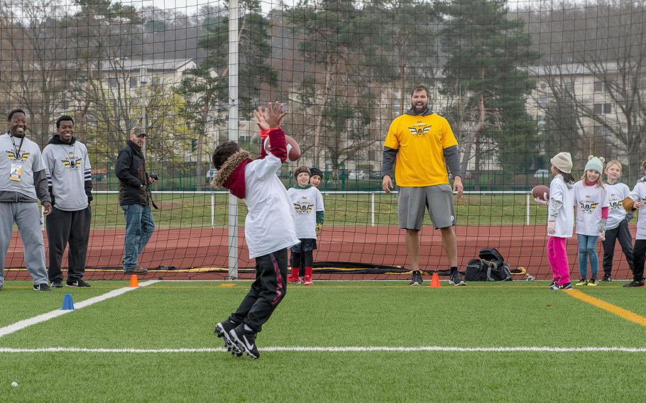 Pittsburg Steelers offensive lineman Alejandro Villanueva passes the ball to a young receiver during a pro camp at Kaiserslautern High School football field Saturday, April 13, 2019. More than 200 kids from around Germany attended the two-day football camp.
