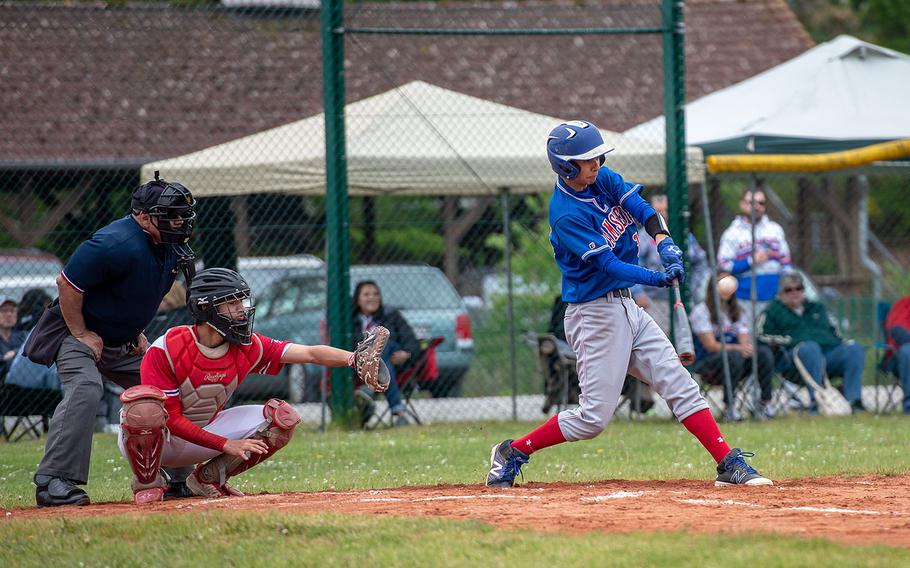 Ramstein's Calvin Delp hits a fly ball during a game between Kaiserslautern and Ramstein High Schools, Saturday, May 18, 2019, at Kapaun Air Station, Germany. 