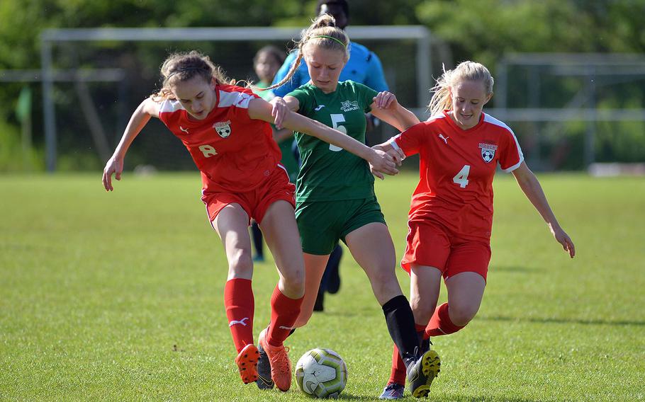 Roxanne Sasse tries to get past the Kaiserslautern defense of Angelina Popovic, left, and Baylee Buys in a Division I semifinal at Reichenbach, Wednesday, May 22, 2019. Naples won 3-0 to advance to Thursday's final against Wiesbaden.