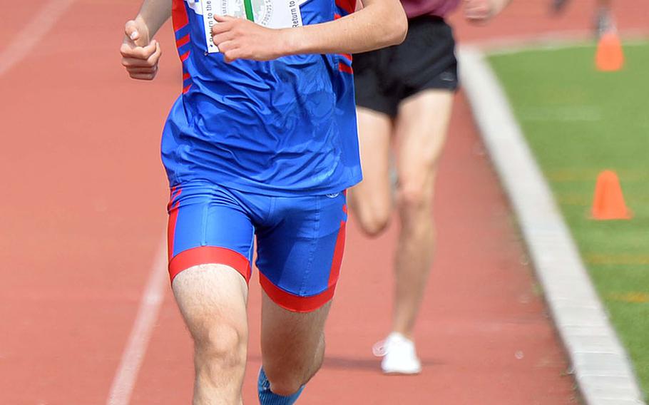Ramstein's Dashiell Rogers powers to the finish line on his way to setting a new DODEA-Europe record in the 3,200-meter run with a time of 9 minutes, 49.21 seconds at the track and field championships in Kaiserslautern.