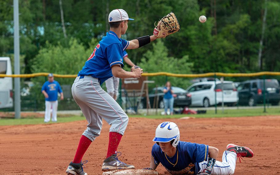 Wiesbaden's Robert Kennedy slides back into first base after a caught fly ball during a game against Ramstein on Day 2 of the boys Division I DODEA-Europe baseball championships, Friday, May 24, 2019. 