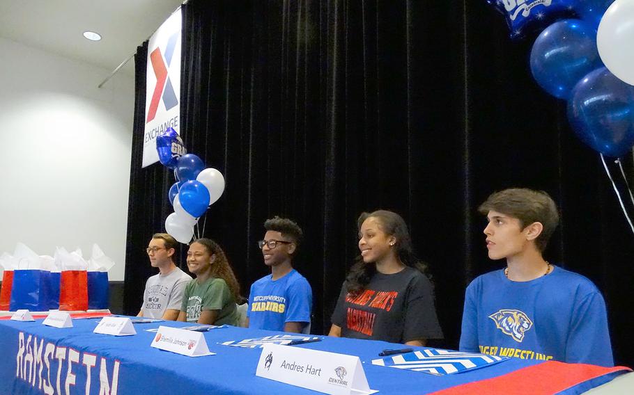 Ramstein seniors, from left, Garrett Erickson, Masaya Archbold, Isaiah Allen, Shemilia Johnson and Andres Hart attend a signing ceremony for college-bound Royal athletes Thursday, June 6, 2019, at the Kaiserslautern Military Community Center on Ramstein Air Base, Germany. Fellow signees Tieran Shoffner and Gabe Fraley were unable to attend the event.        