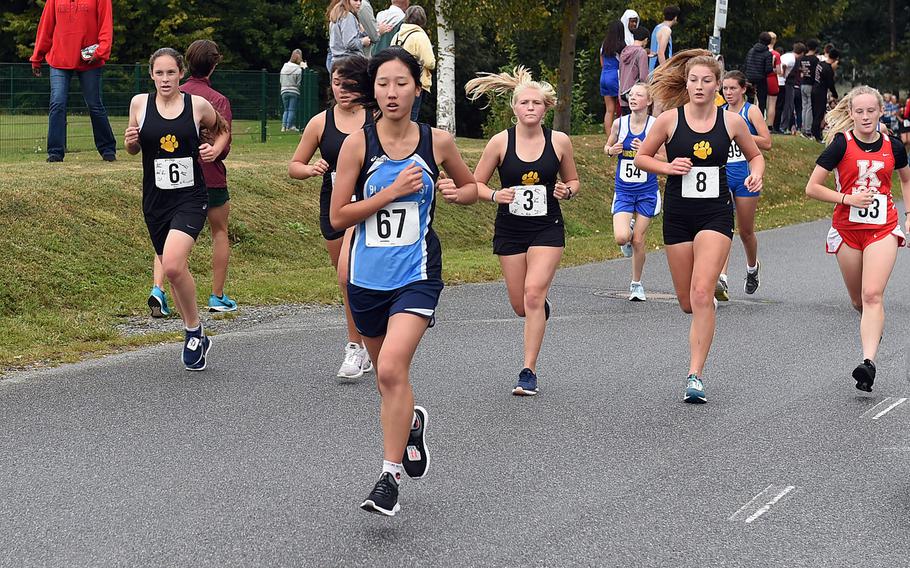 Black Forrest Academy's Siyoung Kim runs ahead of a pack of Stuttgart Panthers at the cross country race at Vilseck, Germany, Saturday, Sept. 7, 2019. 