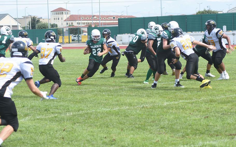 Wildcat J.J. Krieger makes a quick cut away from Cougars defenders on Saturday, Sep. 7, 2019 at Naples Middle High School. The Wildcats beat the Cougars 26-6.
