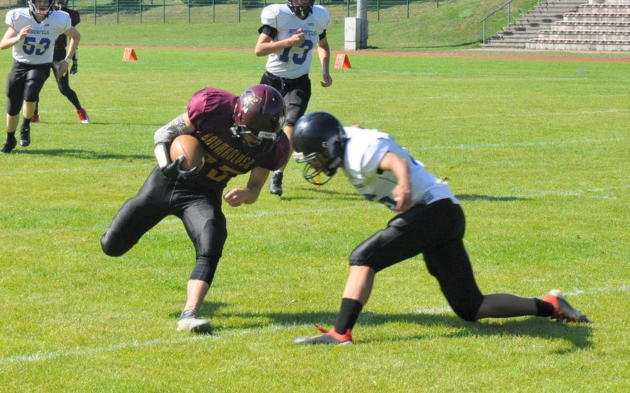 Baumholder ball carrier Wilbur Turgeon collides with a Hohenfels defender in Hohenfels' 21-12 victory Saturday, Sept. 14, 2019, at Baumholder, Germany.
