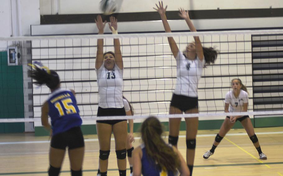 Naples Wildcat Fiona O'Connor jumps up to block an attempted kill by Jaguar Averi Chandler during a five-game match that Sigonella won on Saturday Sept. 14, 2019 at Naples Middle High School. 