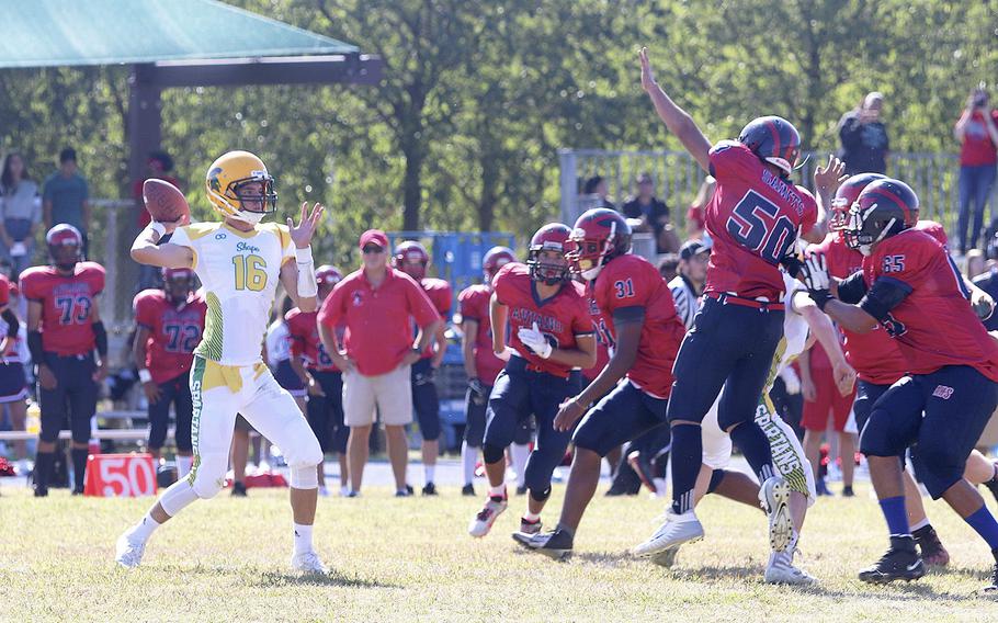 Matthew Owen, quarterback for the SHAPE Spartans, winds back to throw a pass during the Aviano Saints' 52-16 victory on Saturday, Sept. 21, 2019.