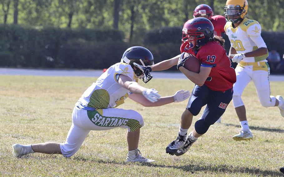 Jace Boren, a wide receiver for the Aviano Saints, tries to break away from a SHAPE defender during the game Saturday, Sept. 21, 2019.