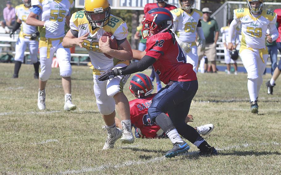 Sam Hennig carries the ball for SHAPE in a 52-16 loss to Aviano on Saturday, Sept. 21, 2019.