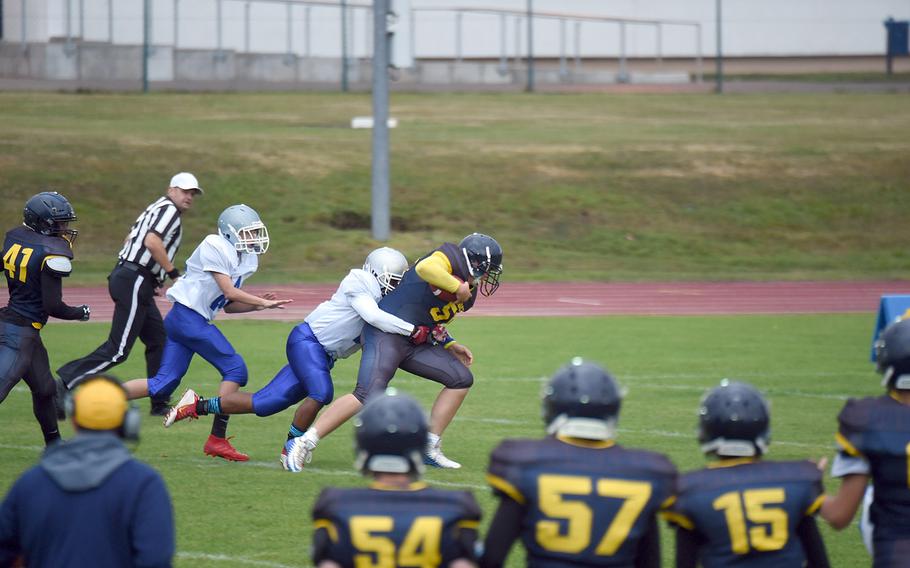 Ansbach's Caison Duplessie trudges through several Brigands in a game against Brussels, at Ansbach, Germany, Friday, Sept. 27, 2019. 
