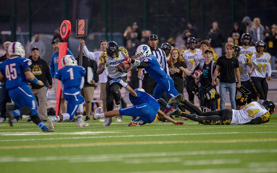 Jordan McCullough tries to break free from tacklers during a game between Ramstein and Stuttgart at Ramstein High School, Friday, Sept.  27, 2019. Stuttgart won the game 37-17.