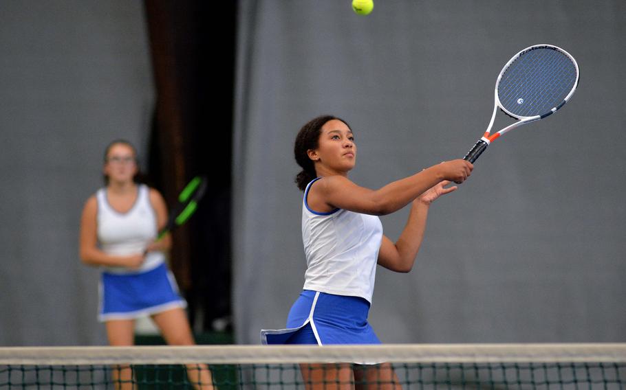 Ramstein's Lydia Woodfork returns a ball at the net as teammate Maddi Svan watches in a girls doubles semifinal at the DODEA-Europe tennis championships in Wiesbaden, Germany, Friday, Oct. 25, 2019. The pair fell to Ramstein teammates Dougie Allison and Isabella Guzaldo 6-4, 7-5.
