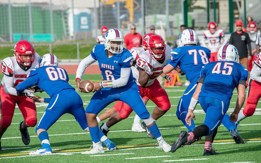 Ramstein's Carl Norman turn to pitch the ball during a game against Kaiserslautern High School at Ramstein Air Base, Germany, Saturday, Oct. 26, 2019. Ramstein won the game 35-21. 