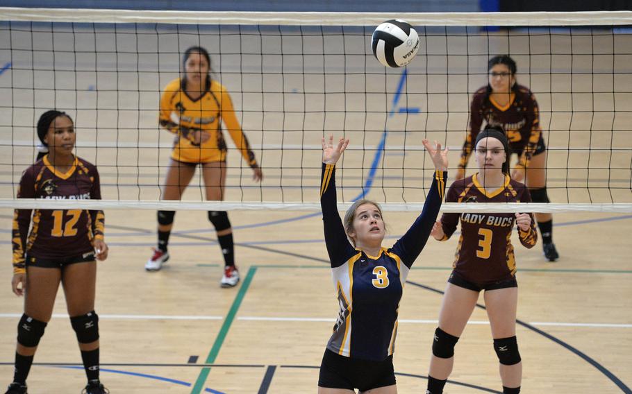 Ansbach's Annika Daniels-Matthews sets the ball for a teammate as Baumholder's Se'maiya Farrow, Lexie Serrato, Grace Pedigo and Sofia Gaona watch from across the net. Ansbach beat Baumholder 15-25, 25-16, 15-8 in a Division III match at the DODEA-Europe volleyball championships in Ramstein, Germany, Oct. 31, 2019. 