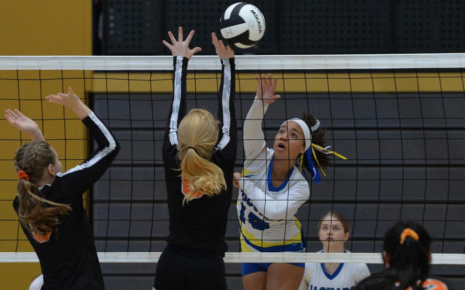 Sigonella's Averi Chandler hits over the Spangdahlem defense of Chloe Price and Jennifer Oppliger in a Division III match at the DODEA-Europe volleyball championships in Ramstein, Germany, Oct. 31, 2019. Sigonella won 25-18, 25-21, 10-15.