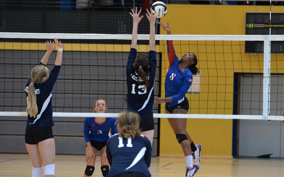 Ramstein's Ahmarie Young hits over the outstretched hands of Lakenheath's Kiera Stover in a Division I match at the DODEA-Europe volleyball championships in Ramstein, Germany, Oct. 31, 2019. Ramstein won 25-7, 25-12, 15-8.
