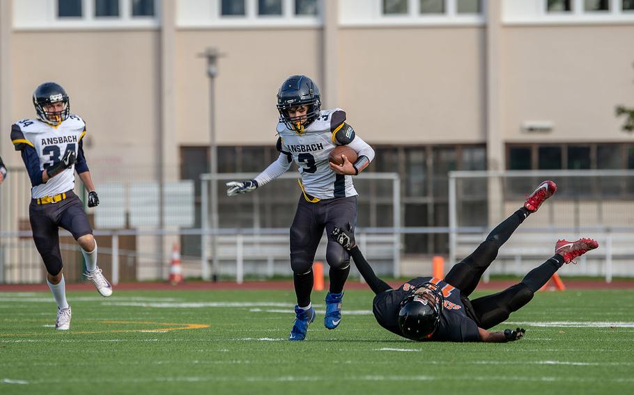 Ansbach's Keoni Ulloa-Galindo breaks a tackle before scoring against Spangdahlem during the Division III Football Championship game at Kaiserslautern High School, Germany, Saturday, Nov. 2, 2019. Spangdahlem won the game 39-26.