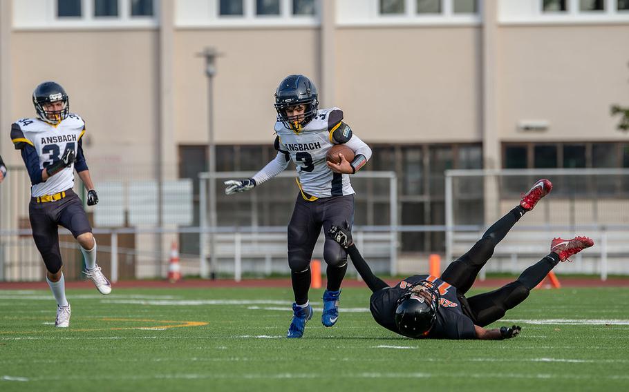 Ansbach's Keoni Ulloa-Galindo breaks a tackle before scoring against Spangdahlem during the Division III Football Championship game at Kaiserslautern High School, Germany, Saturday, Nov. 2, 2019. Spangdahlem won the game 39-26. 