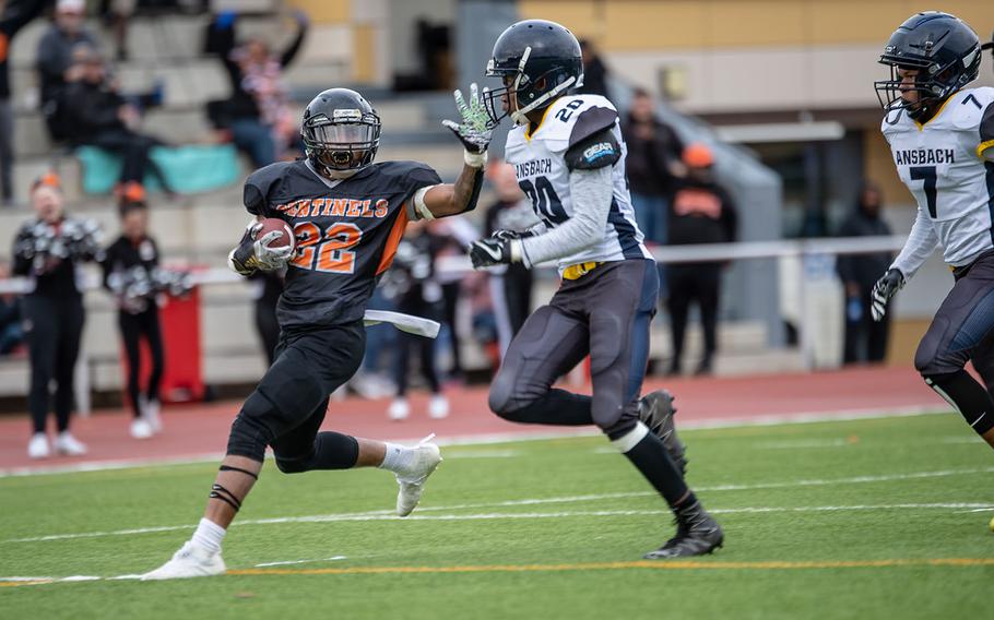 Spangdahlem's Deon Montgomery tries to stiff-arm Ansbach's Josiah Jackson before he is pushed out of bounds during the Division III Football Championship game at Kaiserslautern High School, Germany, Saturday, Nov. 2, 2019. Spangdahlem won the game 39-26.
