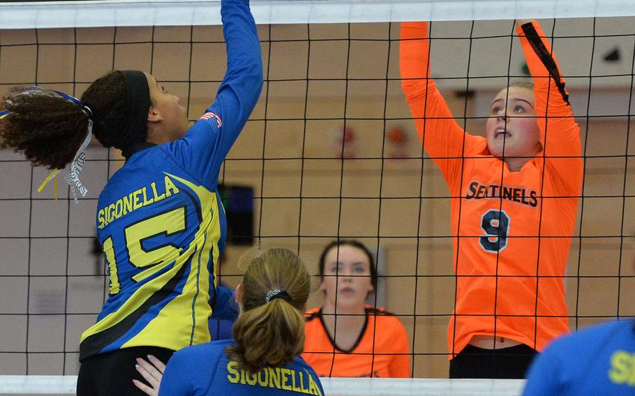 Sigonella's Averi Chandler returns the ball against Spangdahlem's Chloe Price as their teammates Kylee Fall, foreground, and Molly Branson watch. Spangdahlem defeated Sigonella in the Division III final at the DODEA-Europe volleyball championships in Kaiserslautern, Germany, Saturday, Nov. 2, 2019, 22-25, 25-12, 25-20, 26-24. 