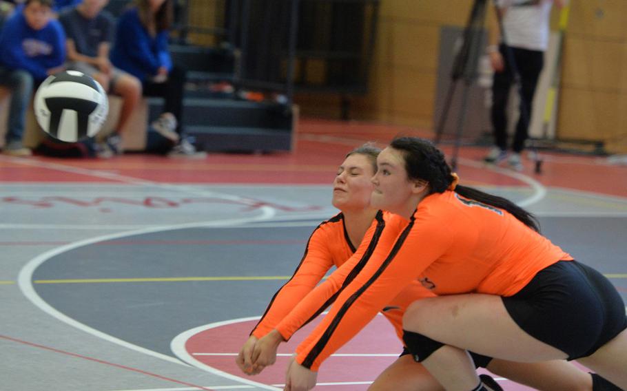 Spangdahlem's Keena Teahon, left, and Molly Branson team-up to dig out a Sigonella serve in the Division III final at the DODEA-Europe volleyball championships in Kaiserslautern, Germany, Saturday, Nov. 2, 2019. Spangdahlem won 22-25, 25-12, 25-20, 26-24. 
