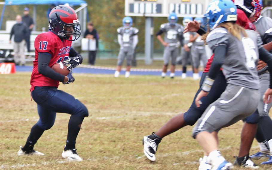 Aviano Saints running back Josiah Cooper runs the ball as Rota Admirals defenders try to stop him during Saturday's DODEA-Europe Division II Championship game held at Aviano.  