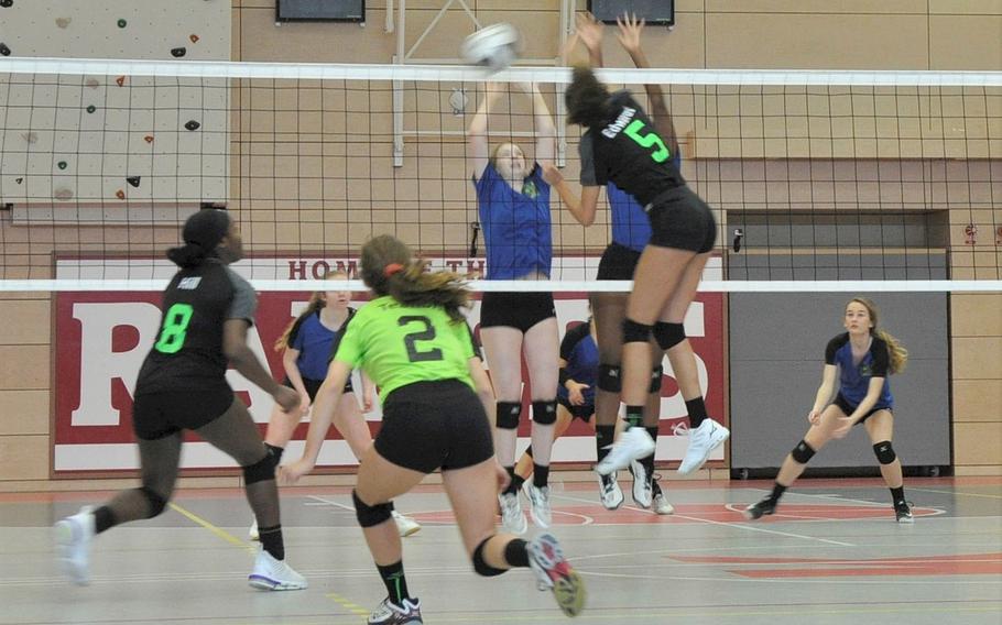 Wiesbaden hitter Cassy Edwards is challenged by two Blue team defenders in the 2019 DODEA-Europe volleyball all-star matches Saturday at Kaiserslautern High School in Kaiserslautern, Germany.