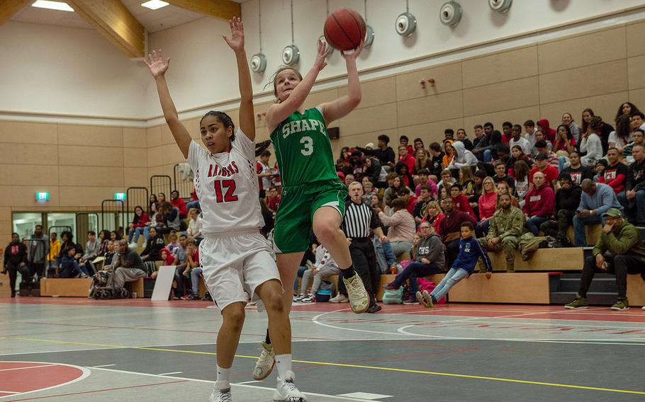 SHAPE's Gabi Shultz takes a shot during a basketball game between SHAPE and Kaiserslautern at Kaiserslautern High School, Germany, Friday, Dec. 6, 2019. SHAPE won the game 45-40.