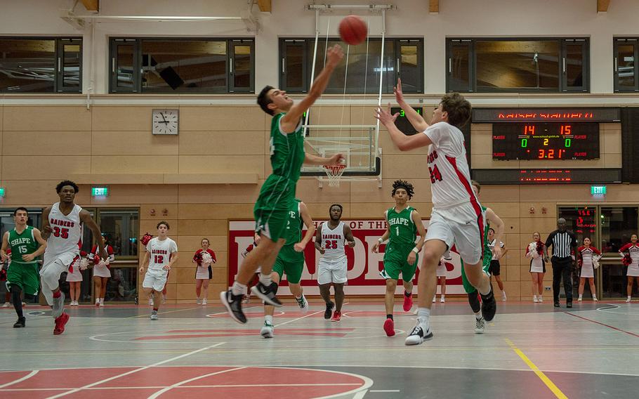 Players battle for the ball during a basketball game between SHAPE and Kaiserslautern at Kaiserslautern High School, Germany, Friday, Dec. 6, 2019. Kaiserslautern won the game 56-32. 