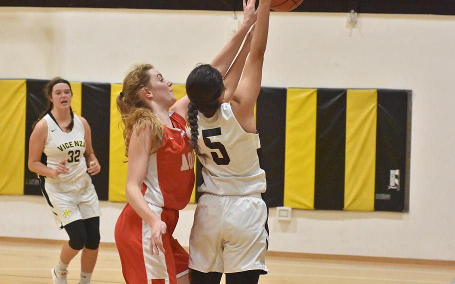 American Overseas School of Rome's Evan Park tries to block the shot of Vicenza's Bridget Craig but gets called for the foul in the Cougars' 41-33 victory on Friday, Dec. 6, 2019.