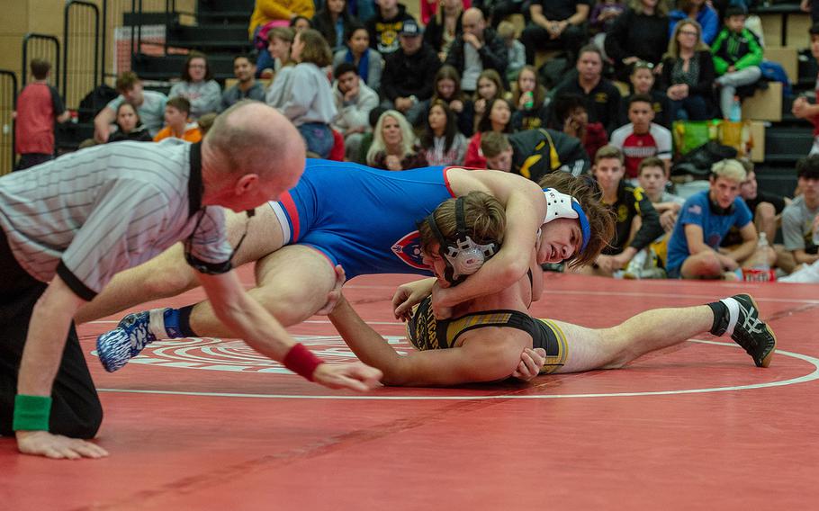 Ramstein's Sean Hogan rolls Stuttgart's Noah Carges during a wrestling tournament at Kaiserslautern High School, Germany, Saturday, Jan. 18, 2020.   Hogan won the watch with a pin.  