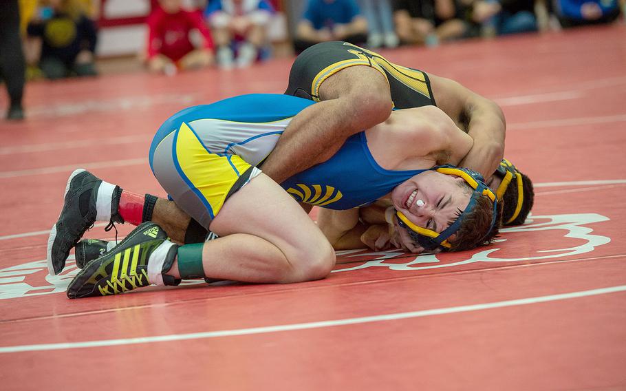 Wiesbaden's Caleb Rothmeyer avoids a pin from Stuttgart's Noah Lurvey during a wrestling tournament at Kaiserslautern High School, Germany, Saturday, Jan. 18, 2020.   Rothmeyer won the watch 16-8.  