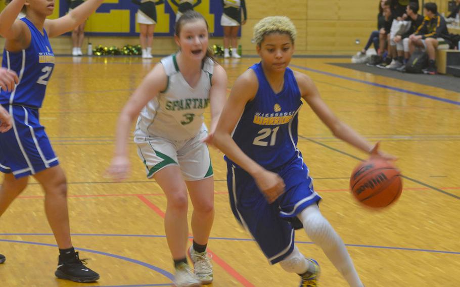 Wiesbaden's Alynna Palacios dribbles past SHAPE defenders. The Spartans beat the Warriors 40-26. 