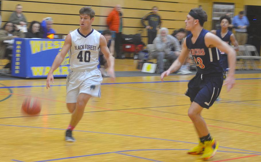 Black Forest Academy's Ruben Kuhn penetrates the Lakenheath defense during a game played at Wiesbaden High School. The Falcons beat the Lancers 76-48.