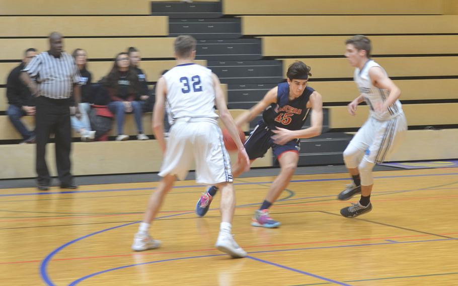 Lakenheath's Gabriel Stephenson dribbles past the Black Forest Academy's defense during a game played at Wiesbaden High School. The Falcons beat the Lancers 76-48.