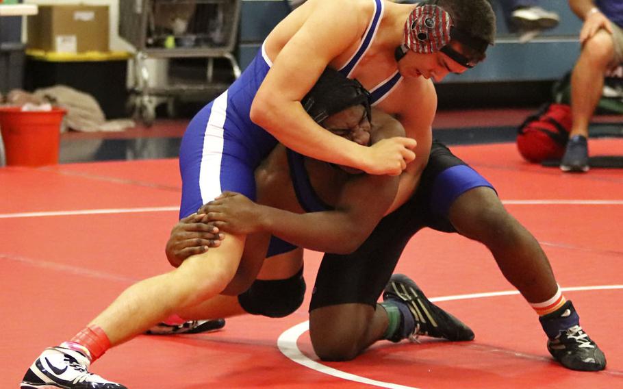 Easton Colvin of the Rota Admirals attemps to gain the upper hand against Brooklyn Davis of the Hohenfels Tigers in the 170-pound weight class' first place match during Saturday's wrestling tournament held at Aviano. Colvin won the match by pin.
