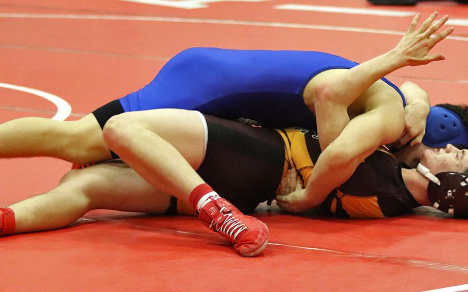 Jaiden Workman of the Hohenfels Tigers attemps to pin Tyler Butterfield in Saturday's wrestling tournament held at Aviano.