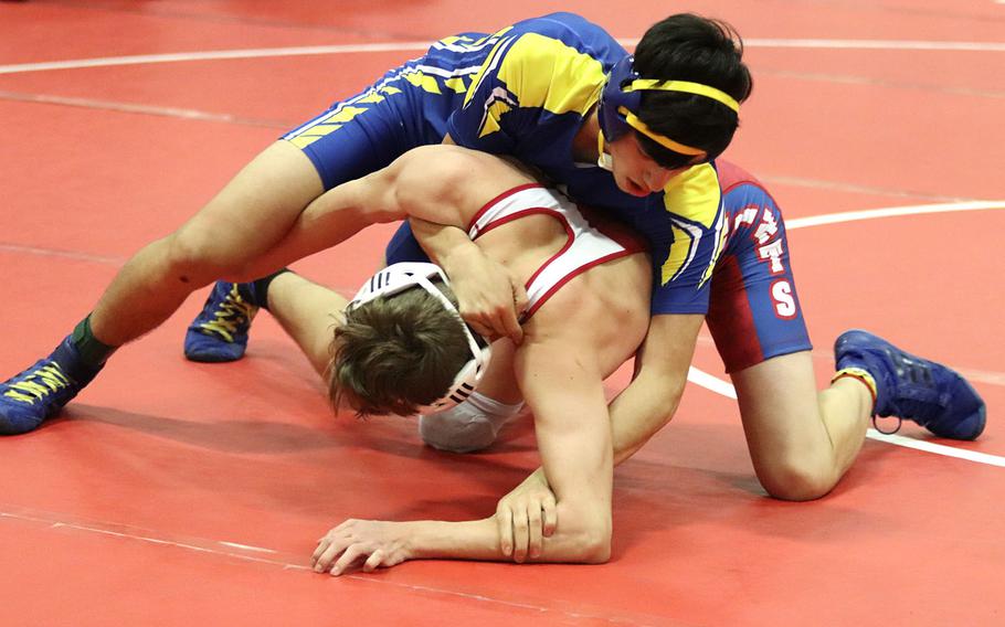 Noah Bachicha of the Sigonella Jaguars tries to pin Keegan Elliot of the Aviano Saints during Saturday's wrestling tournament held at Aviano. Bachicha was able to pin Elliot for the win in the 138-pound weight class.