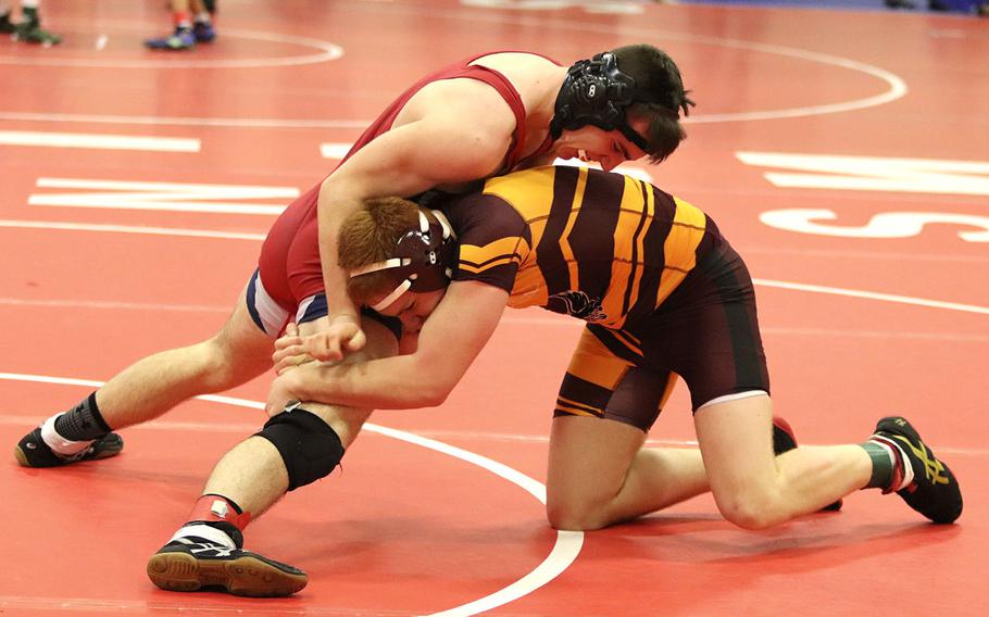 Nick Smith of the Aviano Saints tries to free his leg from Vilseck's Bradley Farris' hold during a wrestling tournament held at Aviano, Saturday, Jan. 18. Smith won the match 18-9.