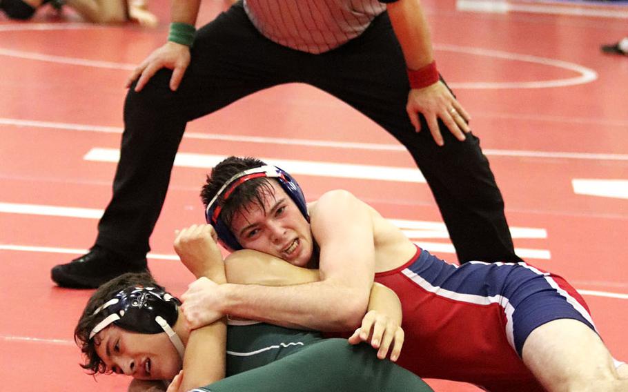 Michael Hauser of the Aviano Saints tries to pin Mason Topper of the Naples Wildcats during Saturday's wrestling tournament held at Aviano. Hauser won the match 3-0 and finished in first place in the 145-pound weight class.