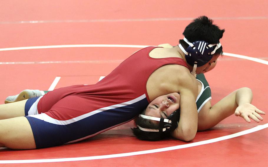 Daniel Merrill of the Aviano Saints works on pinning Geronimo Pena of the Naples Wildcats in the 160-pound weight class, during Saturday's wrestling tournament held at Aviano. At the end of the day, Naples came in second place with 89 points.
