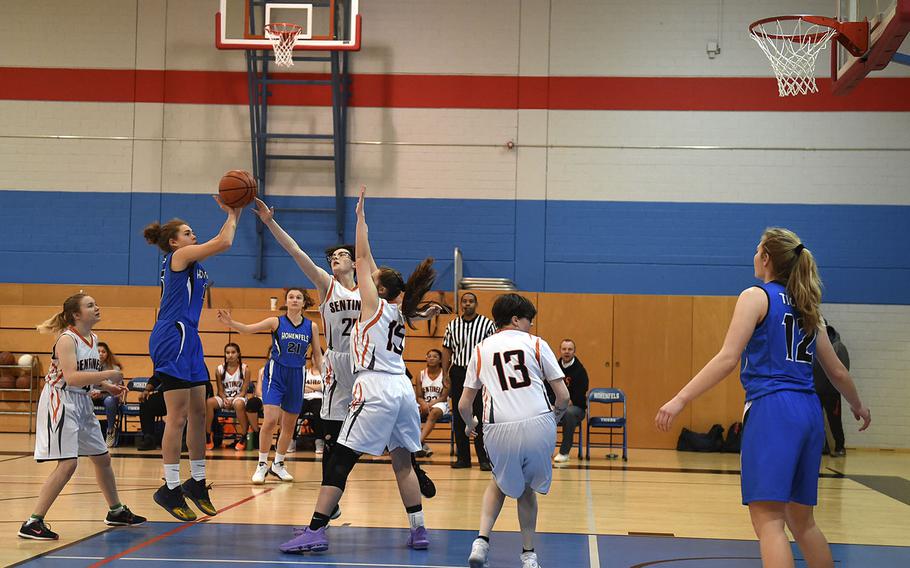 Spangdahlem Sentinel Lorelai Vargo blocks a shot from Hohenfels Tiger June Smith, during Saturday's girls varsity basketball game held at Hohenfels. The Sentinels beat the Tigers 41-39.