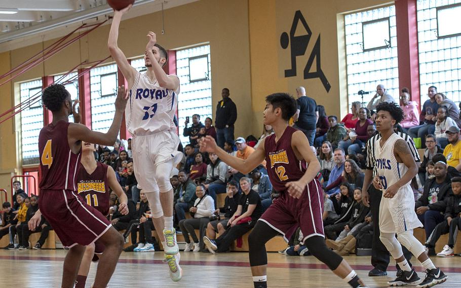 Ramstein's Luis Figerouo takes a shot during Saturday's boys varsity basketball game against Baunholder, held at Baumholder. Ramstein won the game 52-44.