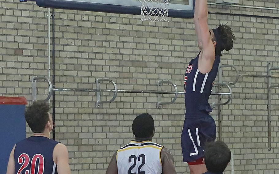 Lancer Marchall Dixon slams the ball in at the end of the Lakenheath-Stuttgart basketball game Saturday, Feb. 1, 2020 on RAF Lakenheath. 
